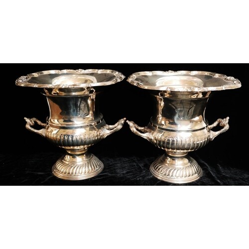 A PAIR OF 20TH CENTURY SILVER PLATED WINE BOTTLE HOLDERS Cam...