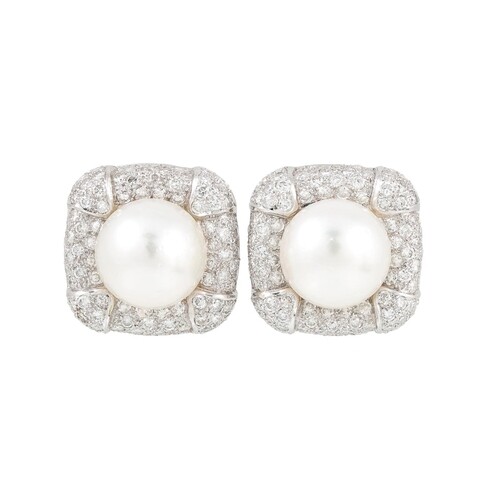 A PAIR OF PEARL AND DIAMOND CLUSTER EARRINGS, the central pe...