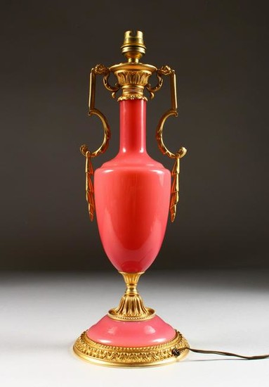 A PINK GLASS TWO-HANDLED URN SHAPED LAMP. 16ins long.