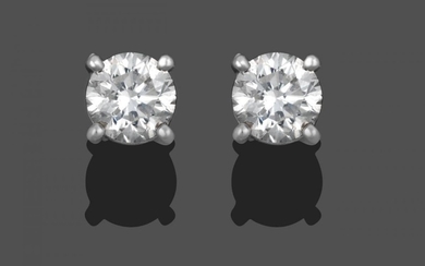 A Pair of Diamond Solitaire Stud Earrings, the round brilliant...