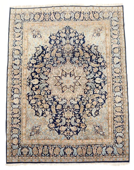 A Persian Keshan carpet, classic medallion design on blue base. 20th century. 386×273 cm.