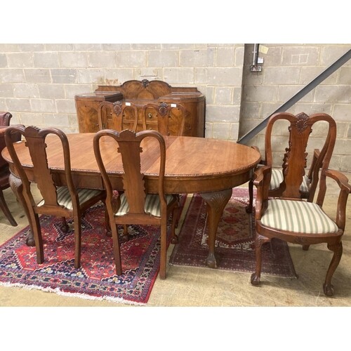 A Queen Anne style figured walnut dining suite comprising ex...