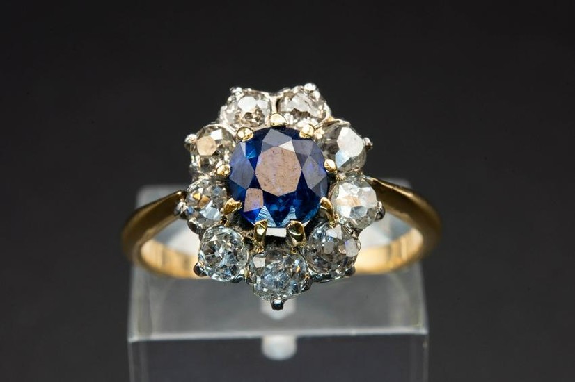 A SAPPHIRE AND DIAMOND CLUSTER RING, the oval cut