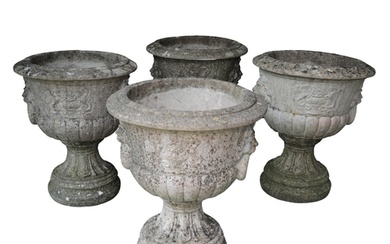 A SET OF FOUR RECONSTITUTED STONE NEO-CLASSICAL URNS 20th c...