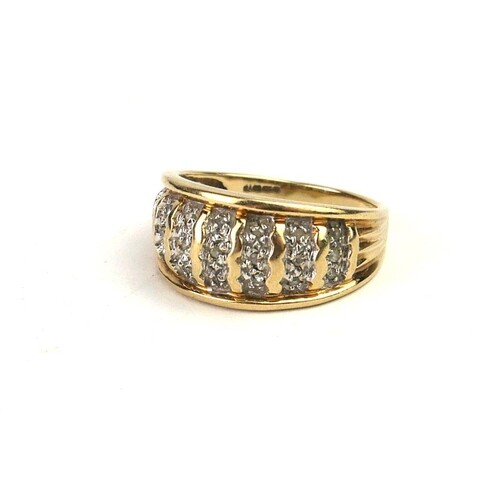 A VINTAGE 9CT GOLD AND DIAMOND RING A tapering wide band of ...