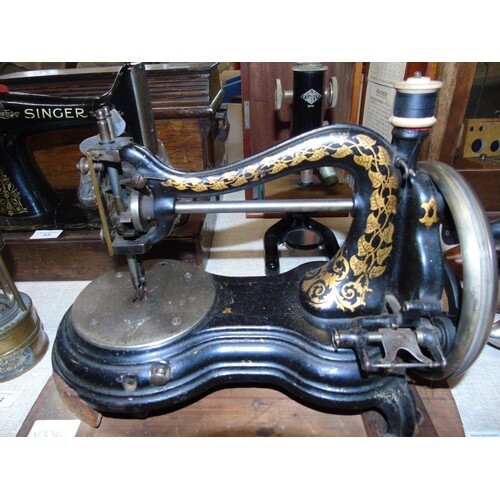A Victorian "Cat Back" sewing machine by Jones (missing a fo...