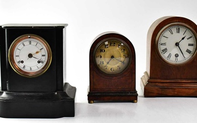 A Victorian slate-effect ebonised wooden mantel clock, together with an...