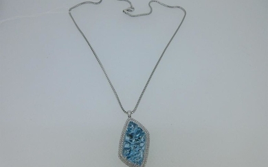 A blue topaz and diamond pendant and chain cased by