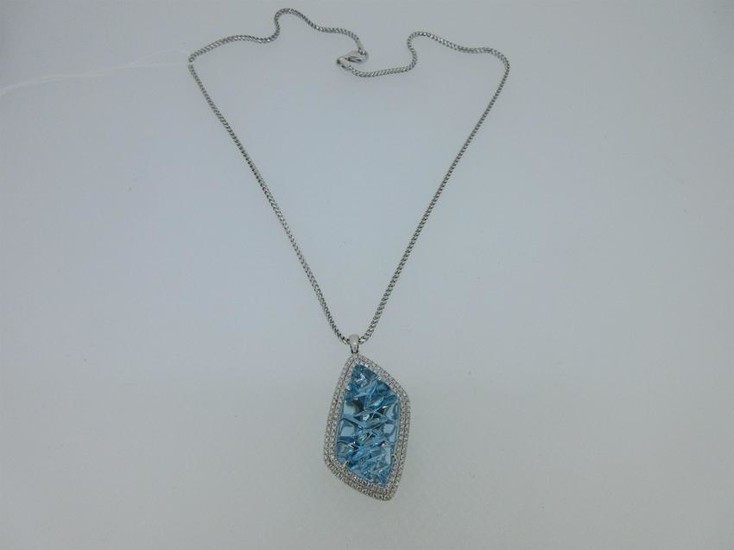 A blue topaz and diamond pendant and chain cased by