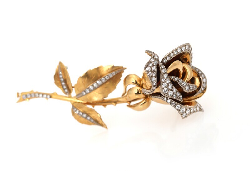 NOT SOLD. A diamond brooch in the shape of a rose set with numerous diamonds,...
