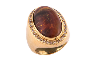 A fire agate and diamond ring The oval...
