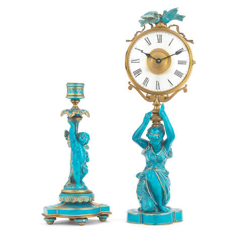 A gilt brass, frosted glass and turquoise glazed ceramic figural mystery time piece together with a similarly glazed figural candlestick the ceramic figural components, late 19th century, the timepiece component, 20th century