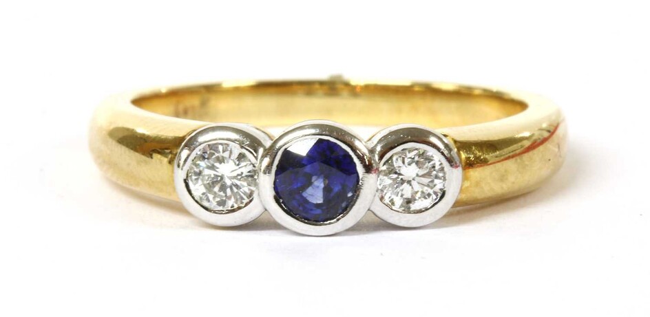 A gold sapphire and diamond three stone ring