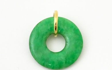 A green jade coloured hardstone pendant with yellow metal mo...