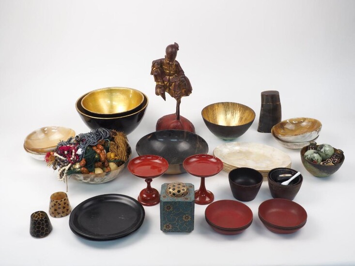 A group of Oriental lacquer items, 20th century, comprising: two trays, three stands, a large red bowl, four small red bowls, two red tazza, two black and gilt bowls, two black small dishes, two tea bowls; together with two large and two small horn...