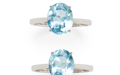 A group of blue topaz and fourteen karat white gold rings