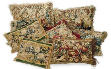 A group of eight tapestry cushions, 18th century and adapted, with fruit and flowers motifs, comprising a set of four, 33 x 48cm; a pair with green velvet borders and backs, 27 x 42cm; and two further single cushions (8)