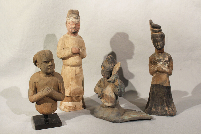 A group of four Chinese painted pottery figures and half figures, perhaps Han Dynasty and later
