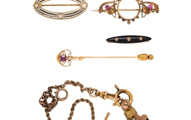 A group of gold and metal pins and accessories