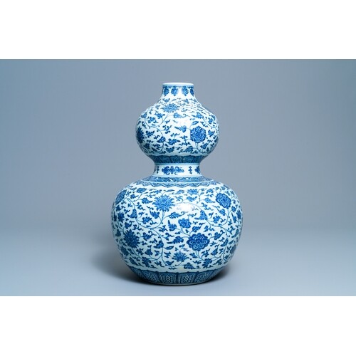 A large Chinese blue and white double gourd vase with floral...
