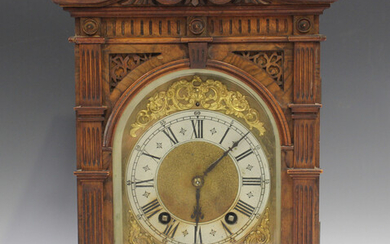 A late 19th century German walnut cased mantel clock with eight day movement striking on two gongs