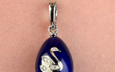 A limited edition 18ct gold blue enamel egg pendant, with diamond swan highlight, by Fabergé.