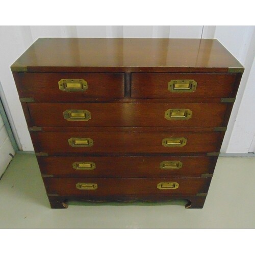A mahogany campaign chest with brass brackets and inset swin...
