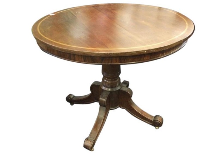 A mahogany drum table, the circular top inlaid with...