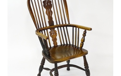 A mid 19thC ash and elm Windsor chair with a double bowed ba...