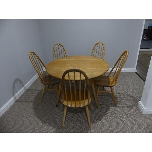 A mid 20thC Ercol elm and beech drop leaf Dining Table, the ...