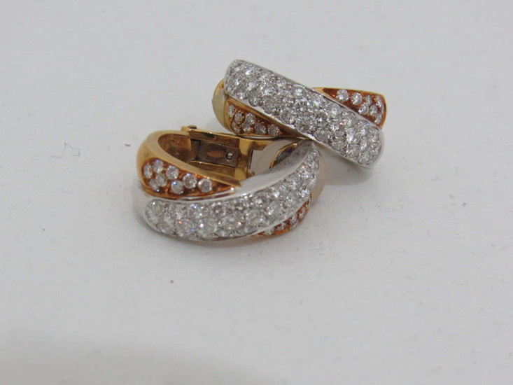 A pair of 18K white and yellow gold earrings,...