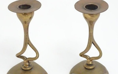 A pair of Art Nouveau brass and copper candlesticks