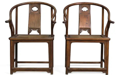 A pair of Chinese elm horseshoe back armchairs Late Qing dynasty With...