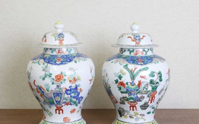 A pair of Chinese famille verte vases and covers