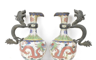 A pair of Chinese late Qing dynasty cloisonne ewers, both ha...