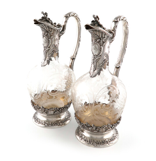 A pair of French silver-mounted glass claret jugs
