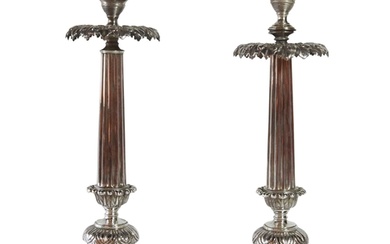 A pair of German silver candlesticks of tapered form upon ci...