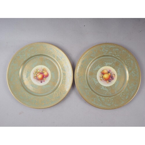 A pair of Royal Worcester cabinet plates with celadon glazed...