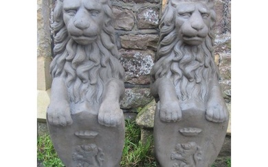 A pair of cast composition stone pier/garden ornaments in th...