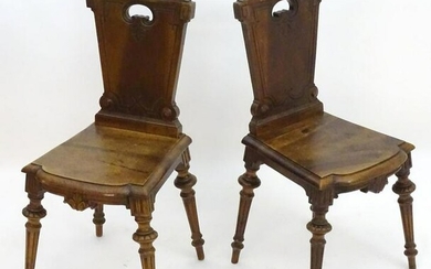 A pair of late 19thC walnut hall chairs stamped 'Gueret