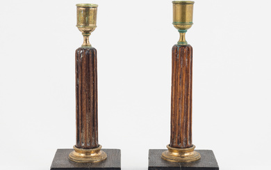 A pair of late Gustavian gilt brass, mahogany, and bog oak candlesticks, circa 1800.