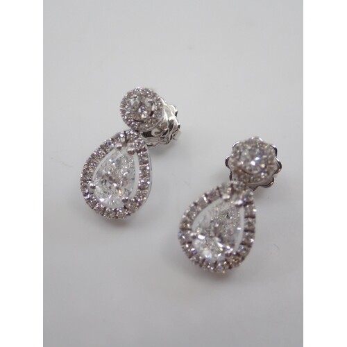 A pair of pear shaped diamond earrings with GIA certificates...