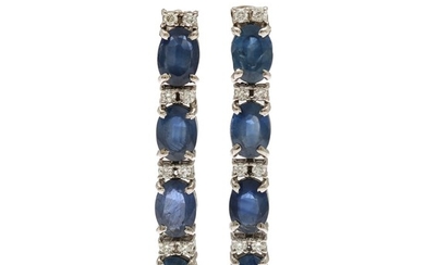 A pair of sapphire and diamond ear pendants each set with four oval-cut sapphires and eight brilliant-cut diamonds, mounted in 14k white gold. L. 3.6 cm. (2)