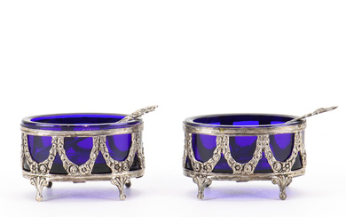 A pair of silver and glass salt pans.