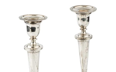 A pair of silver candlesticks, with reeded borders and knopped...