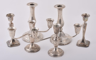 A pair of silver coloured twin branch candelabra