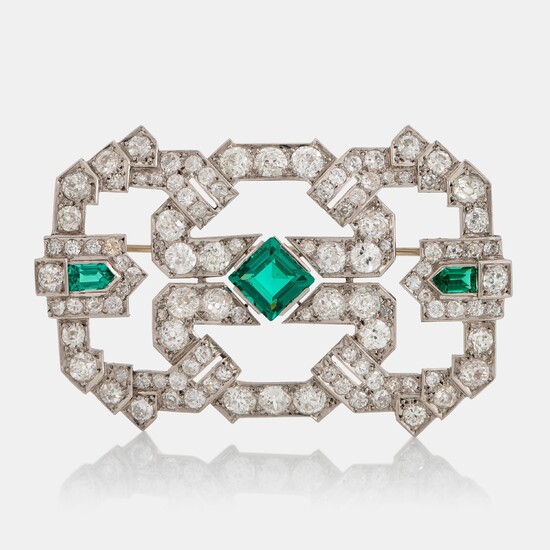 A platinum brooch set with old-cut diamonds and faceted green paste