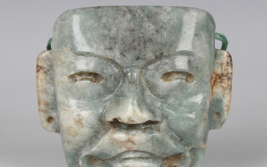 A pre-Columbian Olmec style carved jade mask, probably 900-450 BC, bearing collector's label to