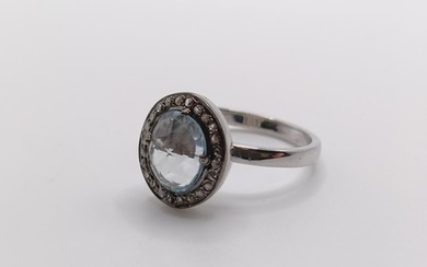 A ring set with an oval checkerboard-cut aquamarine, and a h...
