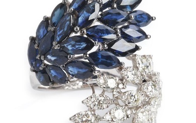 A sapphire and diamond ring set with a circular-cut and numerous marquise-cut sapphires weighing a total of app. 5.06 ct. and numerous brilliant-cut diamonds weighing a total of app. 1.30 ct., mounted in 18k white gold. Colour: Top Crystal-Crystal...